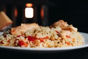 Close-up of a delicious chicken and rice meal with vegetables on a plate.